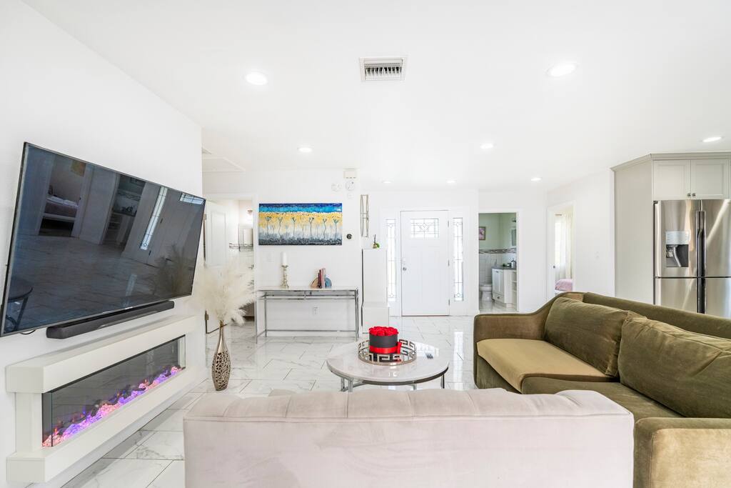 Spacious gathering room with an electric fireplace, AppleTV and Sound system