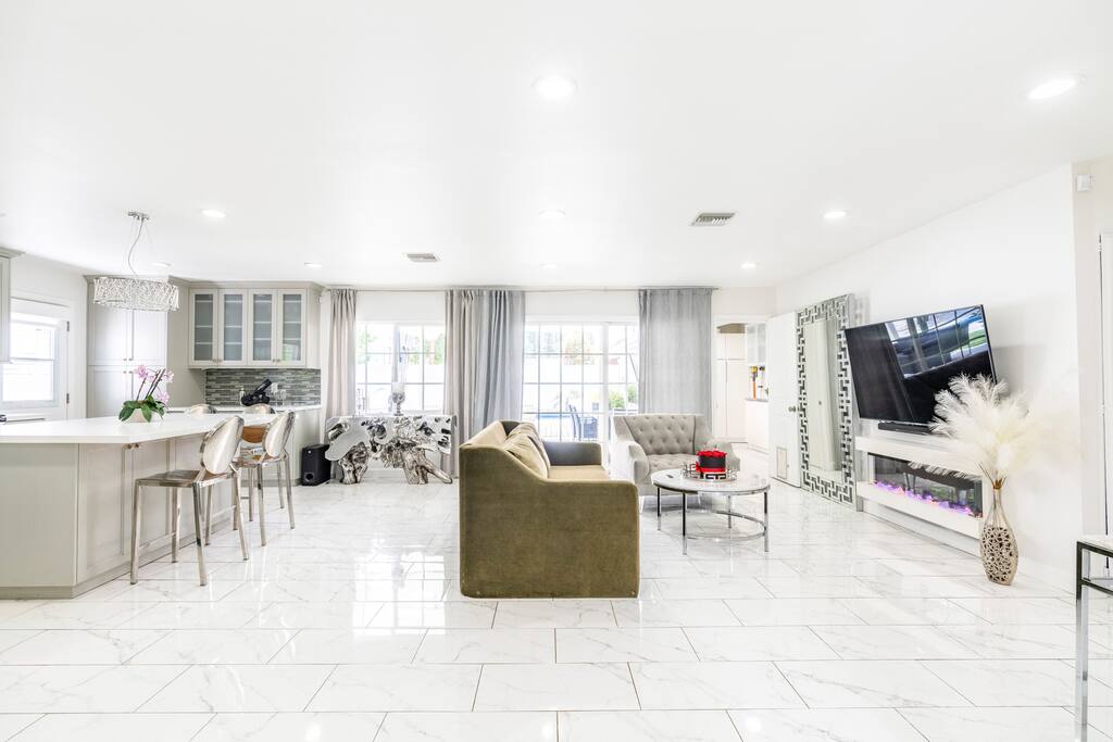 Spacious gathering room with an electric fireplace, AppleTV and Sound system