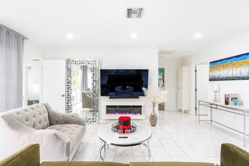 Spacious gathering room with an electric fireplace, AppleTV and Sound system