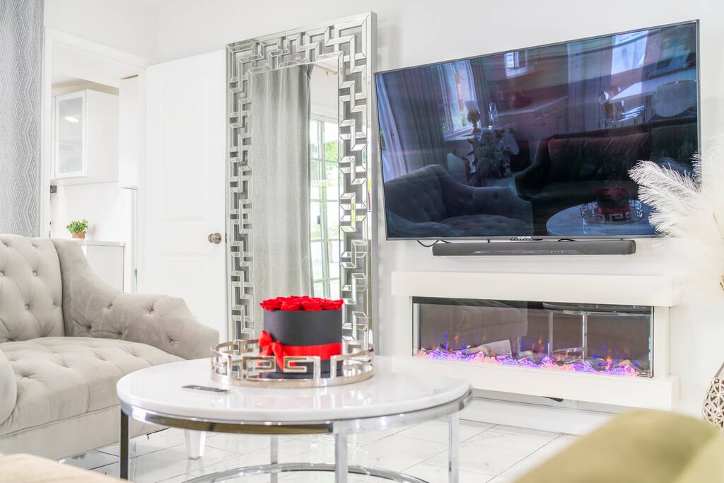 Spacious gathering room with an electric fireplace, AppleTV and Sound system