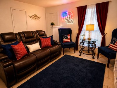 Woodbrook Street home living room with leather sofa and fireplace